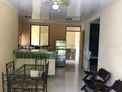 a kitchen and dining room with a table and chairs at Villas Luna de Miel in Carmen