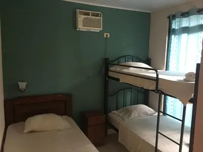 a room with two bunk beds and a fan at Villas Luna de Miel in Carmen