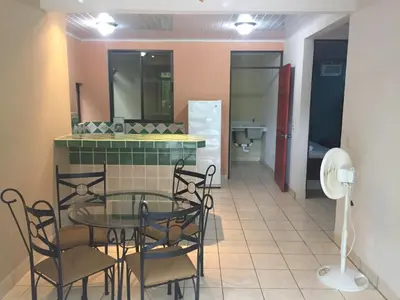 a dining room with a glass table and chairs and a bathroom at Villas Luna de Miel in Carmen