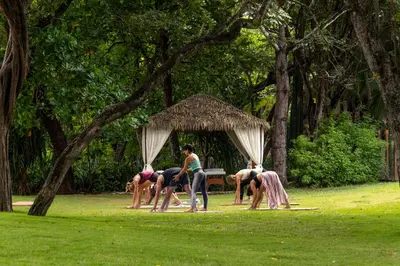 a group of people standing around in a park at Capitán Suizo Beachfront Boutique Hotel in Tamarindo