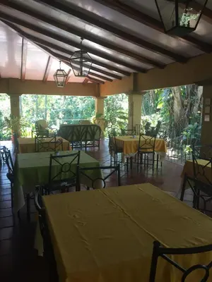 a dining room with tables and chairs and a large window at Trapp Family Country Inn in San Antonio