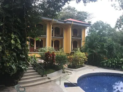 a house with a swimming pool in front of it at Trapp Family Country Inn in San Antonio