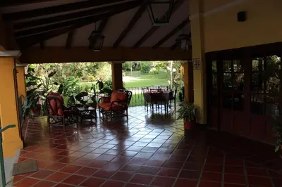 a porch with chairs and tables and a patio at Trapp Family Country Inn in San Antonio