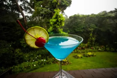 a blue drink in a martini glass with a cherry at Trapp Family Lodge Monteverde in Monteverde Costa Rica