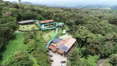 an aerial view of a house in the middle of a forest at Trapp Family Lodge Monteverde in Monteverde Costa Rica