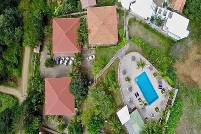 an aerial view of a house with a swimming pool at Tropical Condo with Spectacular Ocean Views, Panoramic Dining Terrace & Quick Walk to Beach in Coco