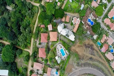 an overhead view of a house with a yard at Tropical Condo with Spectacular Ocean Views, Panoramic Dining Terrace & Quick Walk to Beach in Coco