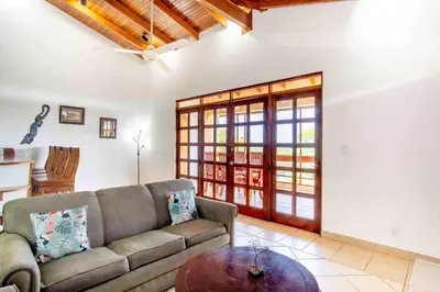 a living room with a couch and a table at Tropical Condo with Spectacular Ocean Views, Panoramic Dining Terrace & Quick Walk to Beach in Coco