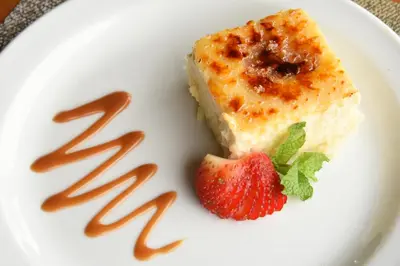 a piece of cake and a strawberry on a plate at Xandari Resort & Spa in Alajuela City