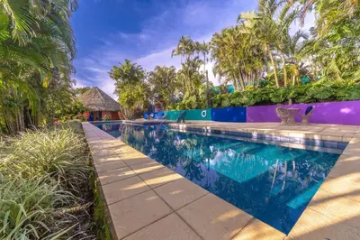 a swimming pool at a resort with palm trees at Xandari Resort & Spa in Alajuela City