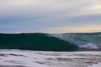 a large wave in the ocean on the beach at Indra Inn in Playa Grande