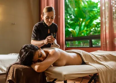 a woman getting her hair washed in a salon at Hotel Arenal Kioro Suites & Spa in Fortuna