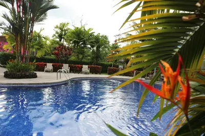 a swimming pool in a resort with a red fish at Hotel Villas Vilma in Fortuna