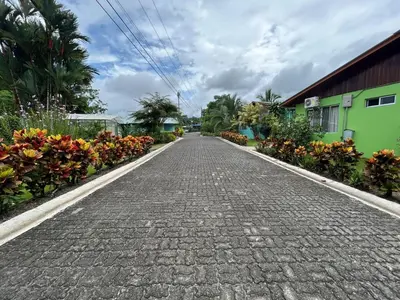 a cobblestone street in a garden with flowers at Hotel Villas Vilma in Fortuna