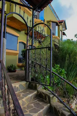 an iron gate to a house with a staircase at Casas del Toro in Monteverde Costa Rica