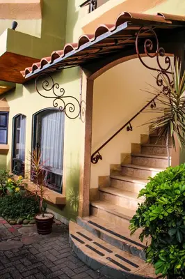 a house with a staircase in front of a house at Casas del Toro in Monteverde Costa Rica