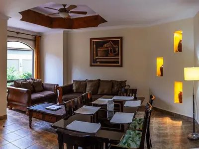 a living room with a couch and tables and chairs at Casas del Toro in Monteverde Costa Rica