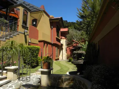 a house with a garden in front of it at Casas del Toro in Monteverde Costa Rica