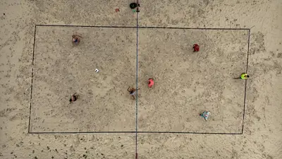 a group of people standing in a square in the sand at Boutique Surf Hotel Rip Jack Inn in Playa Grande
