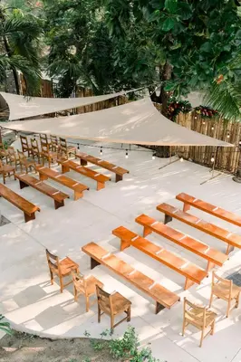 a row of wooden benches in a amphitheater at Boutique Surf Hotel Rip Jack Inn in Playa Grande