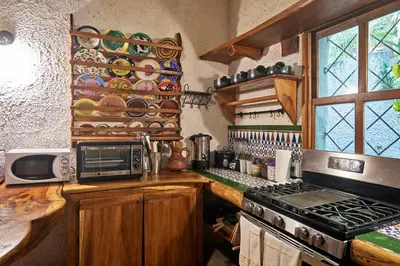 a kitchen with a counter with a stove and a microwave at Villa Havana in Mal País