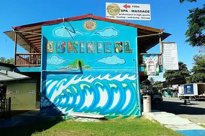 a building with a mural on the side of it at Domi Cabin in Dominical