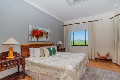 a bedroom with a bed and a window at Bright and cozy 3BR Condo - Bougainvillea - Reserva Conchal Golf Resort in Playa Conchal