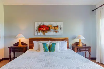 a bedroom with a large bed with two night tables at Bright and cozy 3BR Condo - Bougainvillea - Reserva Conchal Golf Resort in Playa Conchal