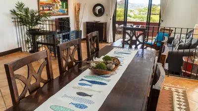 a dining room table with a bowl of plants on it at Bright and cozy 3BR Condo - Bougainvillea - Reserva Conchal Golf Resort in Playa Conchal