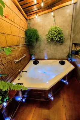 a bathroom with a bath tub with lights in it at Casa Suculenta ,Monteverde con Jacuzzi Privado y Lavandería in Monteverde Costa Rica
