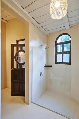 a bathroom with a shower with a glass door at Oceana Beachfront Lux 6BR Retreat Villa Private Yoga Shala in Mal País