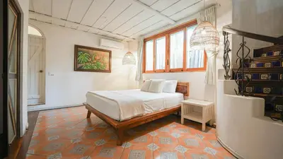 a bedroom with a bed and a window at Oceana Beachfront Lux 6BR Retreat Villa Private Yoga Shala in Mal País