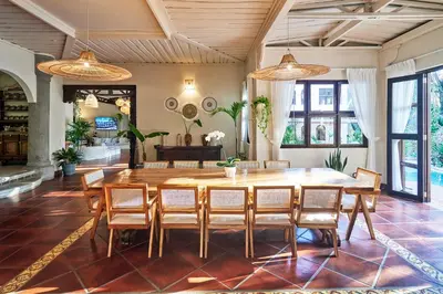 a dining room with a large wooden table and chairs at Oceana Beachfront Lux 6BR Retreat Villa Private Yoga Shala in Mal País