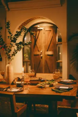 a wooden table with wine glasses and a door at Oceana Beachfront Lux 6BR Retreat Villa Private Yoga Shala in Mal País