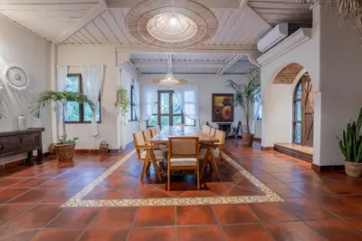 a dining room with a table and chairs at Oceana Beachfront Lux 6BR Retreat Villa Private Yoga Shala in Mal País