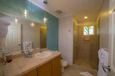 a bathroom with a sink and a shower and a toilet at Del Mar 4N 3 bdr Garden View in Los Suenos in Herradura