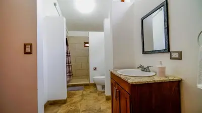 a bathroom with a sink and a toilet and a mirror at Casa tropical - Fabulous tropical house in Tamarindo