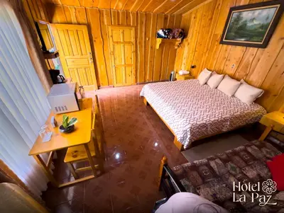 an overhead view of a bedroom with a bed and a table at Hotel La Paz in Poasito