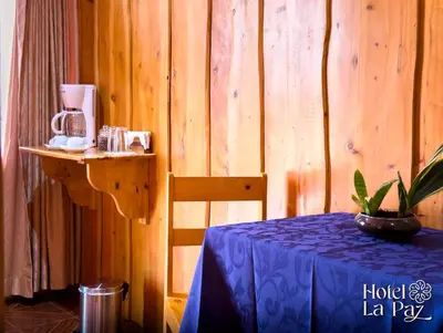 a room with a table with a blue tablecloth on a table sidx sidx sidx at Hotel La Paz in Poasito