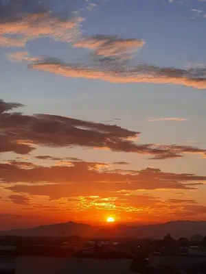 a sunset with the sun in the sky at Alajuela Backpackers Airport Hostel in Alajuela City