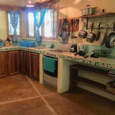 a kitchen with a stove and a stove top oven at Casita de los Sueños in Cabuya