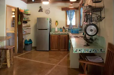 a kitchen with a refrigerator and a counter top at Casita de los Sueños in Cabuya
