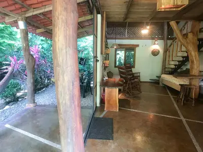 a living room with a staircase in a house at Casita de los Sueños in Cabuya