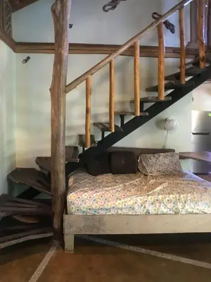 a bedroom with a bunk bed and a staircase at Casita de los Sueños in Cabuya