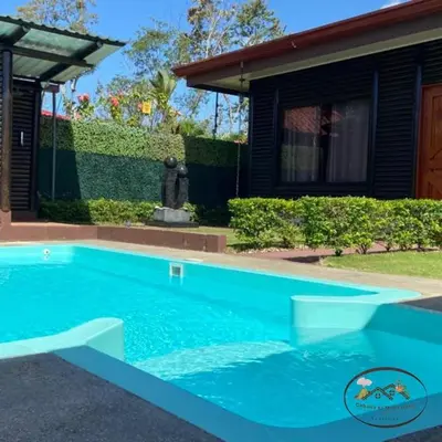a swimming pool in front of a house at Cabaña El Monasterio in Fortuna