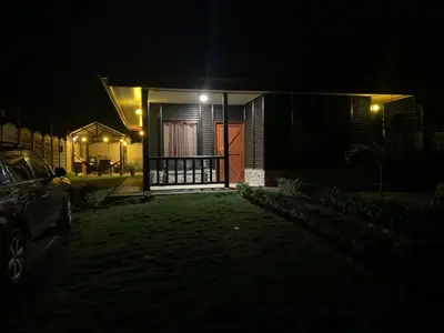 a house at night with a car parked in front of it at Cabaña El Monasterio in Fortuna