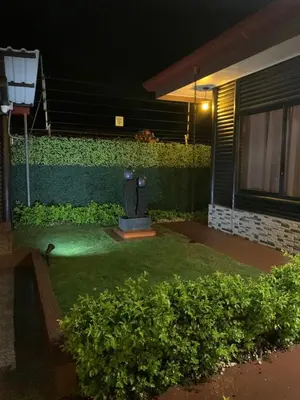 a yard with a toilet in front of a building at night at Cabaña El Monasterio in Fortuna