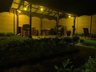a patio lit up at night with lights on it at Cabaña El Monasterio in Fortuna