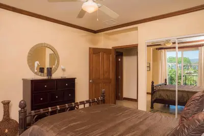 a bedroom with a bed and a mirror at Bay Residence 7C 3 bdr Ocean View in Los Suenos in Herradura