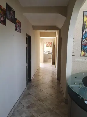 a hallway of a house with a tile floor at HOTEL TERRAZAS BOUTIQUE in Los Yoses